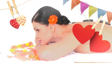 woman lying down with massage stones on her back