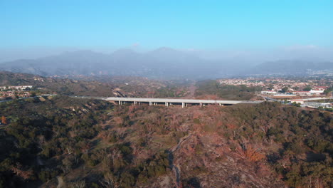 aerial rotation away from a bridge to suburban homes at sunset