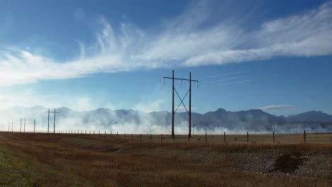 smoke from fire by the powerlines wide