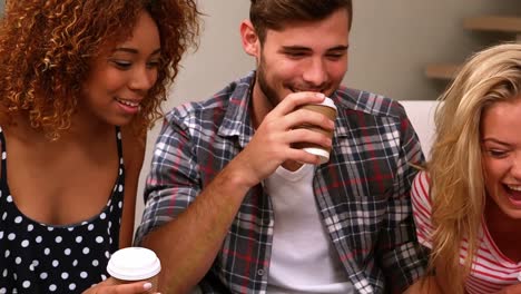 Friends-sitting-on-the-couch-chatting-over-coffee