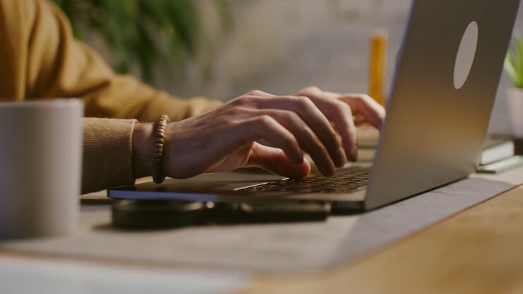 Person Working on Laptop at Home Office