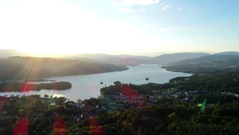 Aerial-shot-moving-back-from-the-houses-on-the-lakeshore-and-surrounding-countryside-at-Lake-Windermere,-Lake-District,-UK