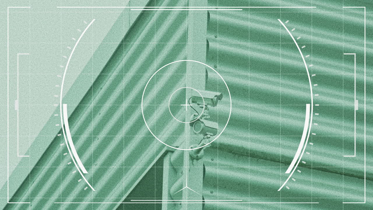 Tilt up to CCTV security cameras on a wall seen through night vision goggles