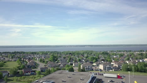 aerial view of residential houses and buildings with saint lawrence river in the distance in quebec city, canada. - sideways