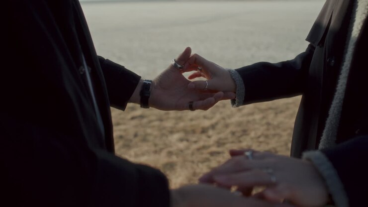 Close-Up of Affectionate Couple Holding Hands in Dry Grass Field