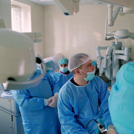 professional doctors with surgical instruments. surgeons in sterile gloves work with modern medical tools. surgeons doing operation. video