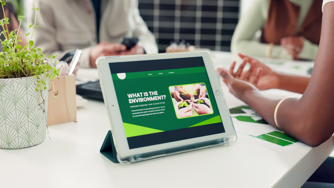 Tablet Displaying Environmental Website During Office Meeting