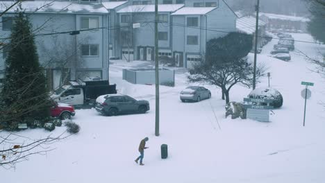 man walking during windy snow storm