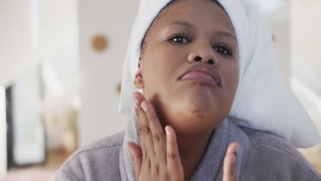 african american plus size woman looking in mirror and touching face, unaltered, slow motion