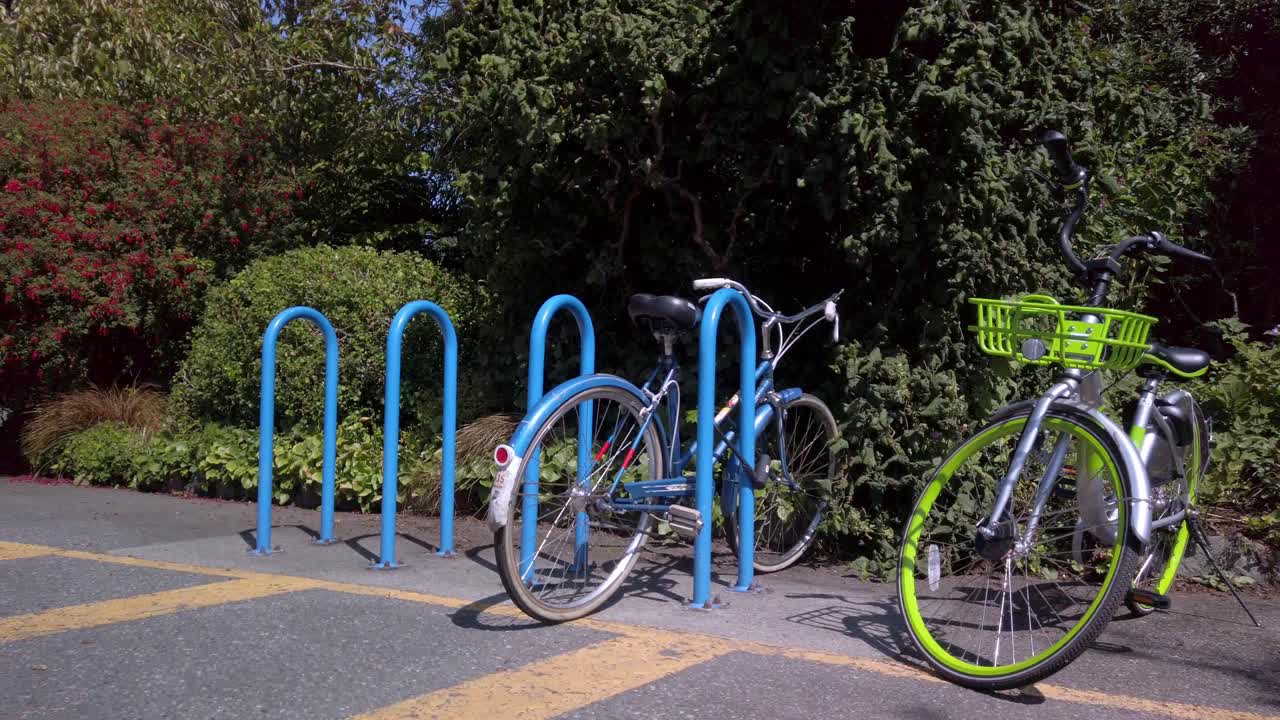 Two bicycles waiting for a ride in a park during summer in Canada Victoria BC