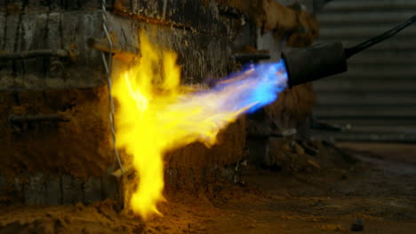 close-up of metal mold heating with blow torch in foundry workshop 4k