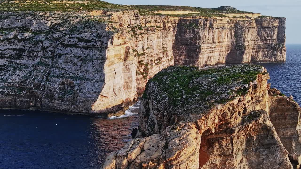 Cliffs and rocks along the coastline of Malta during the early evening