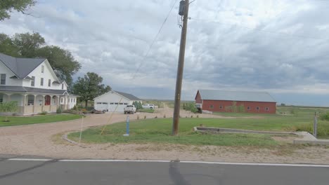 rural drive featuring fields and posts