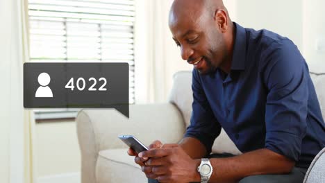 man sitting on a couch while typing on his phone 4k