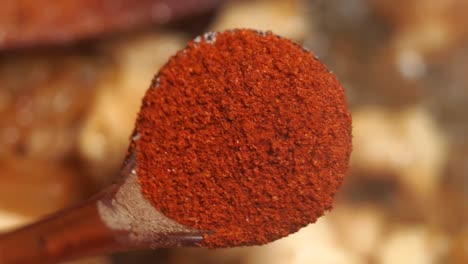 red pepper flakes on a wooden spoon