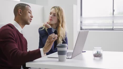 man and woman discussing at the office