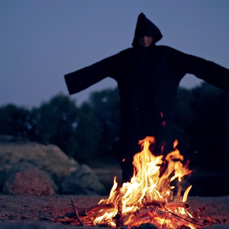 witch in black near bonfire