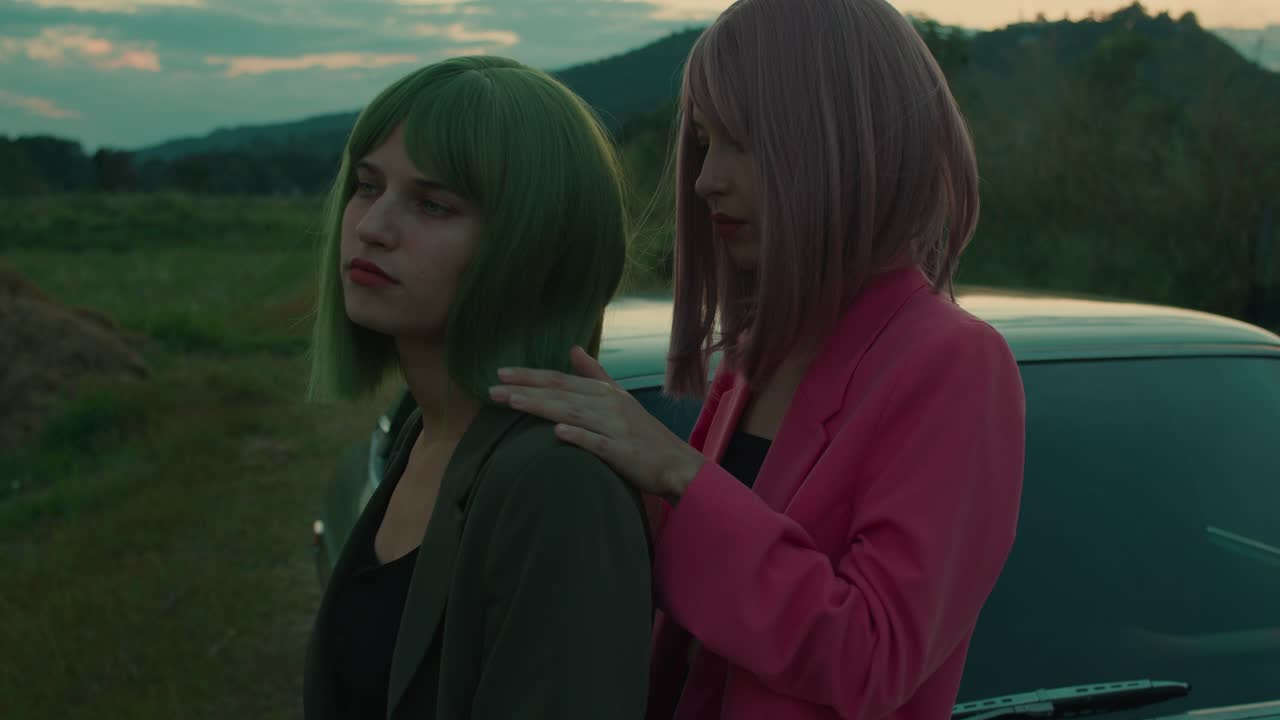 Two Women in Anime Style Embrace by a Retro Car