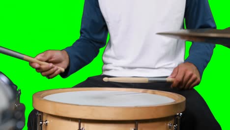 Mid-section-of-drumer-playing-drum