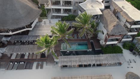 hotel resort with swimming pool, sunbeds and palm trees