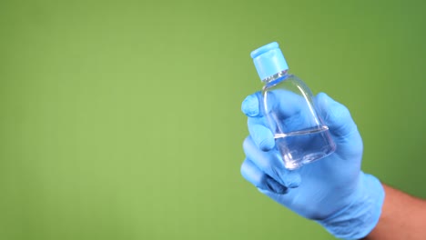 man hand in medical gloves holding sanitizer gel for preventing virus