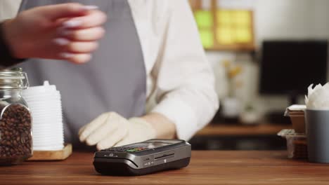 paying with smartwatch in cafe. buying coffee in paper cup. take away hot drink. contactless food shopping. nfc technology concept, fitness bracelet payment.