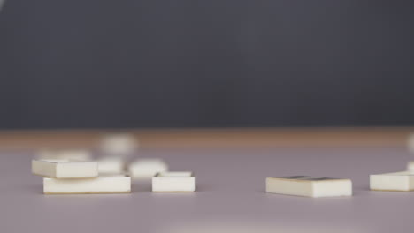 white domino pieces falling onto table