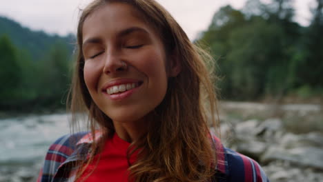 joyful girl standing in summer mountains. satisfied tourist enjoying nature