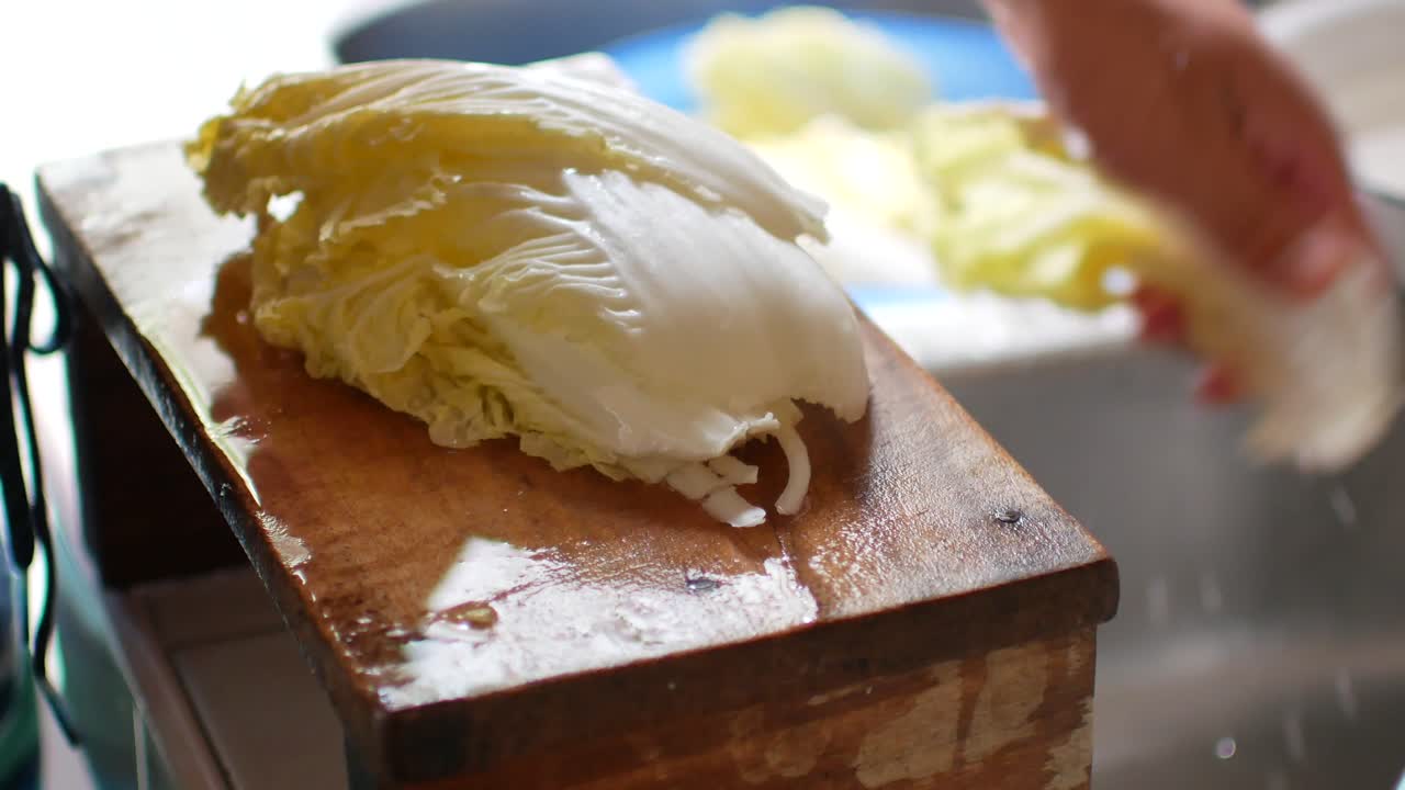 POV to the Nappa cabbage while being cut preparing for korean food cooking