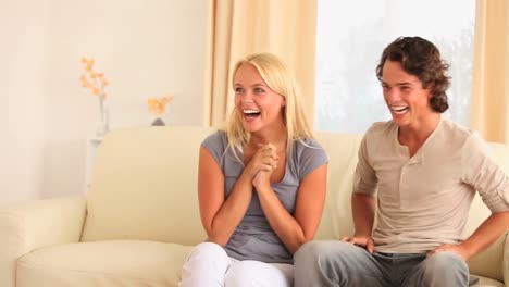 happy couple sitting on a sofa