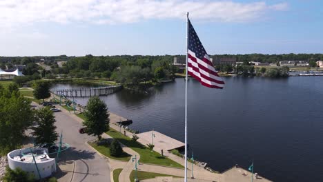 rotation around american flag in the wind with shaw-walker factory in the background