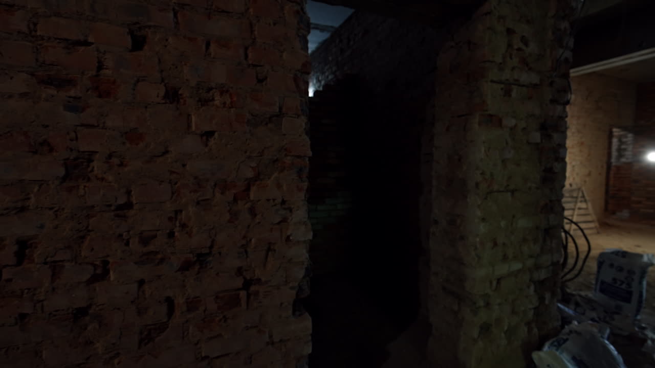 Footage inside the building under construction or reconstruction. Unfinished interior work in the newly built premises. Some workers are at backdrop.