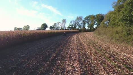 Quad-Bike-Driving-on-a-Field-on-a-Sunny-Autumn-Afternoon-in-Borrby-Österlen-in-South-Sweden-Skåne,-Aerial-Low-Altitude