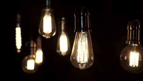 turning light on and off. decorative antique edison style light bulbs hanging from the ceiling.