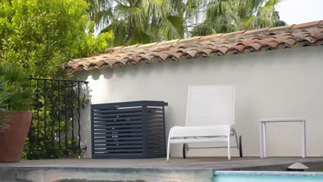 low shot of an air conditioning unit underneath a hatch cage at a villa