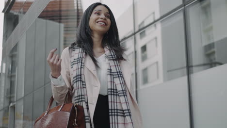 businesswoman walking on street. smiling executive wearing stylish coat outdoors