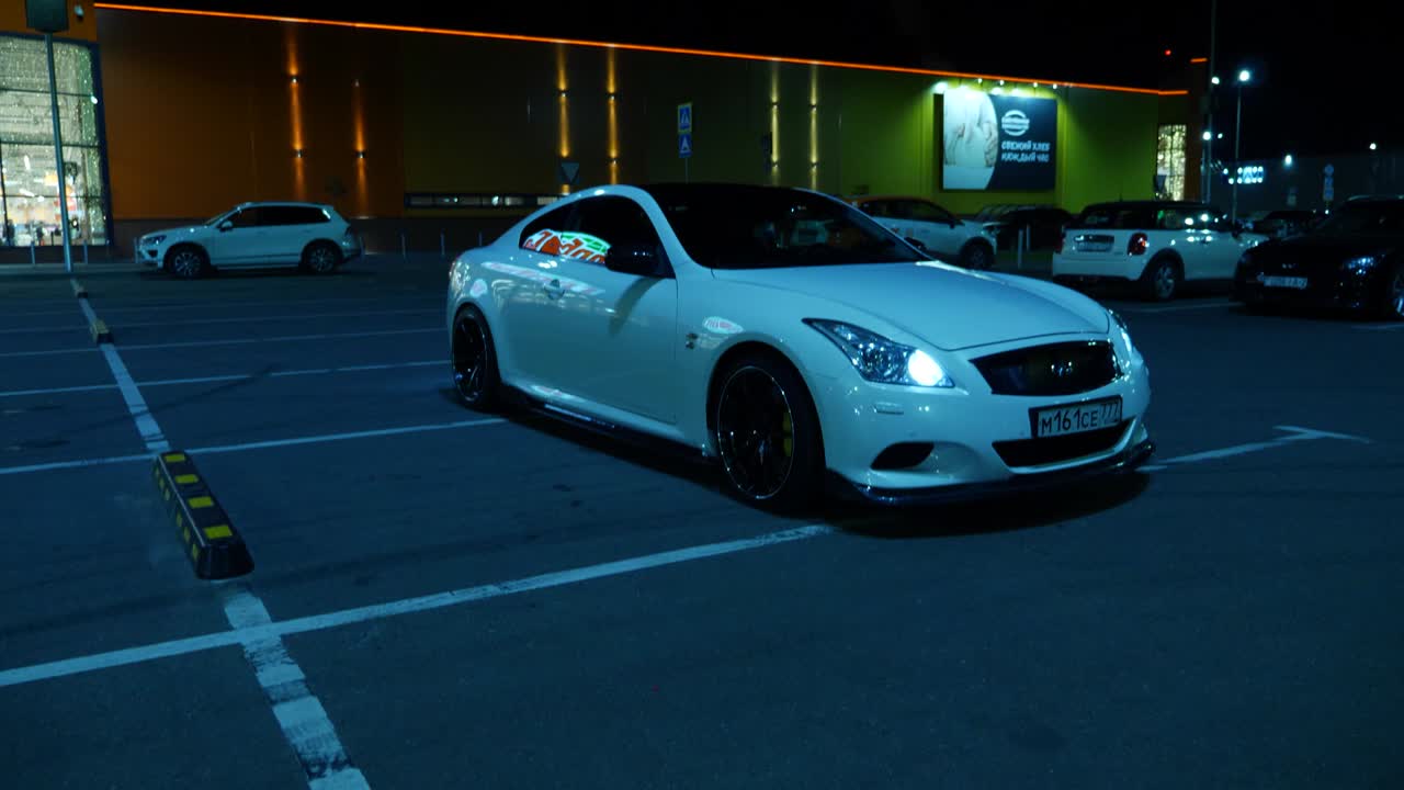 White car in a parking lot