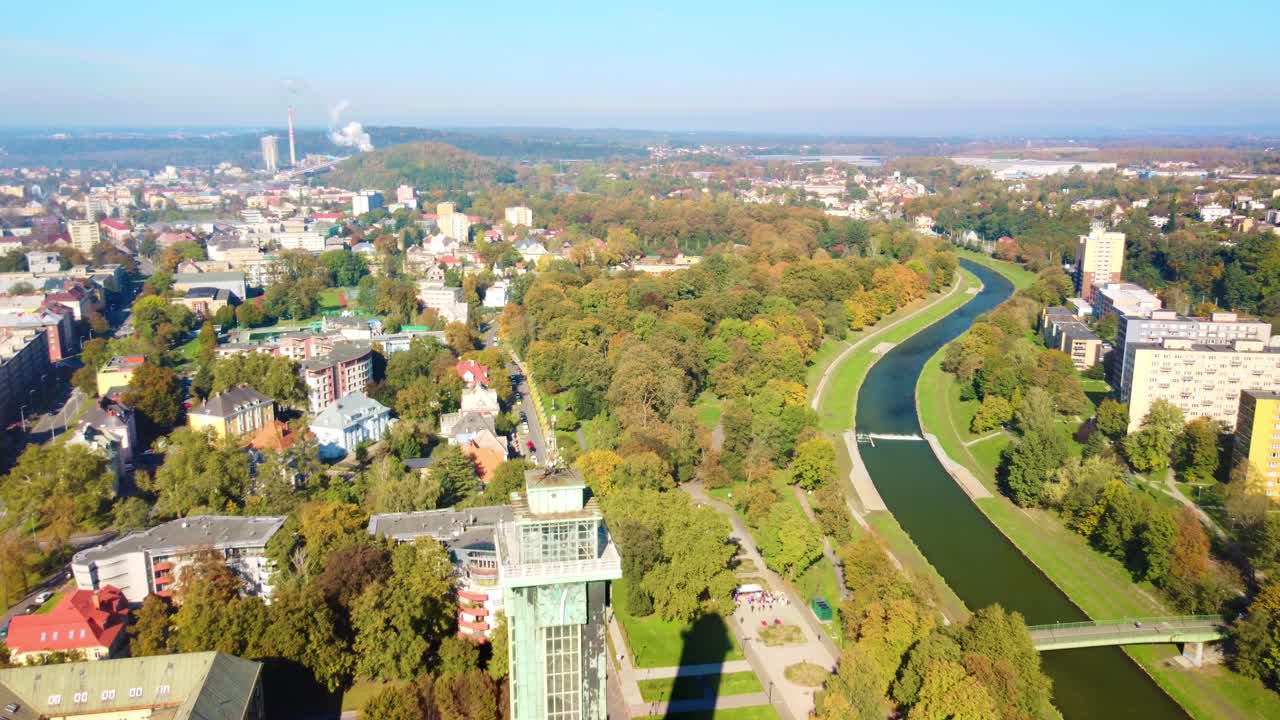 Aerial View of a City with a River and Park in Autumn