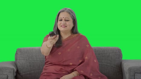 Happy-Indian-old-woman-watching-TV-Green-screen