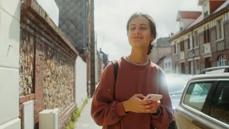 woman using phone in urban street