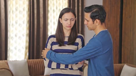 strong indian husband trying to console his upset wife