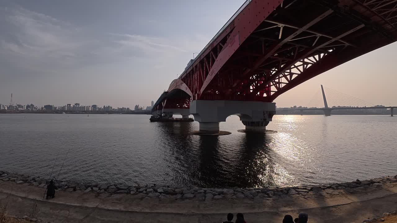 Panoramic View Of Seongsan Bridge Over Seoul's Han River At Sunset, With World Cup Bridge In Background. low angle, panning shot
