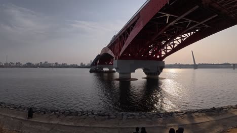 panoramic view of seongsan bridge over seoul's han river at sunset, with world cup bridge in background. low angle, panning shot