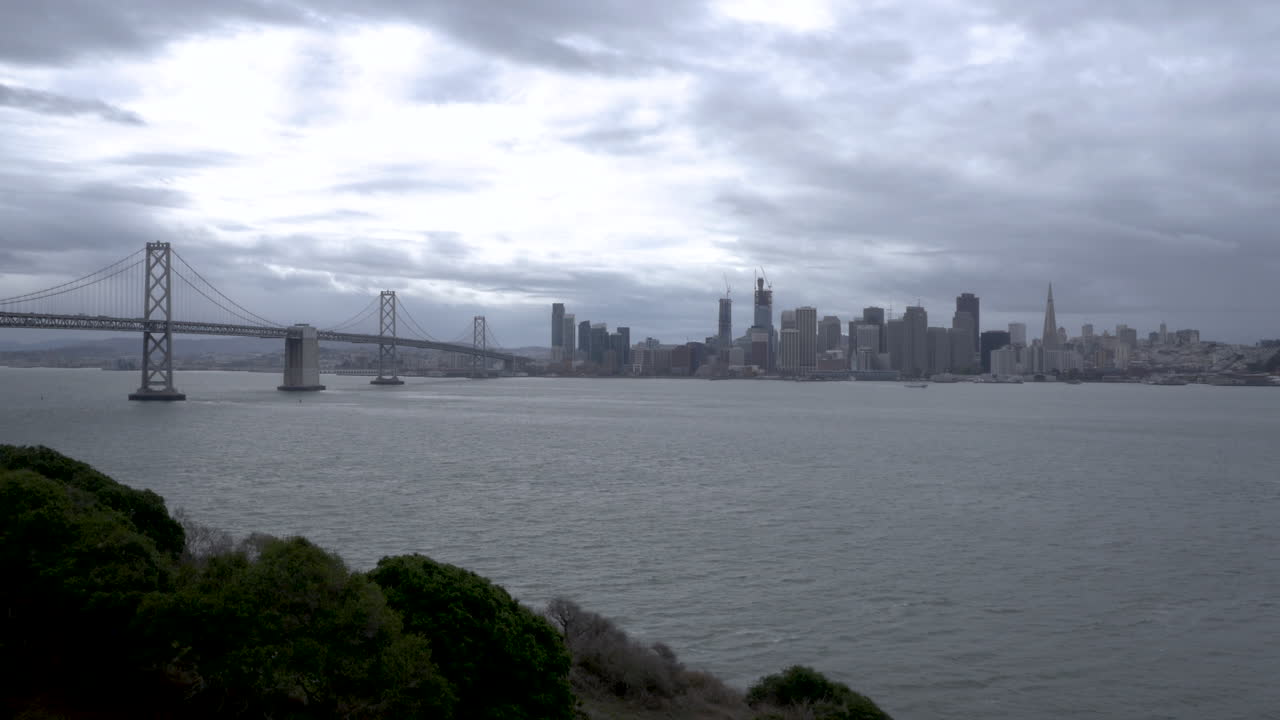 San Francisco skyline with Bay Bridge across the bay from a hillside