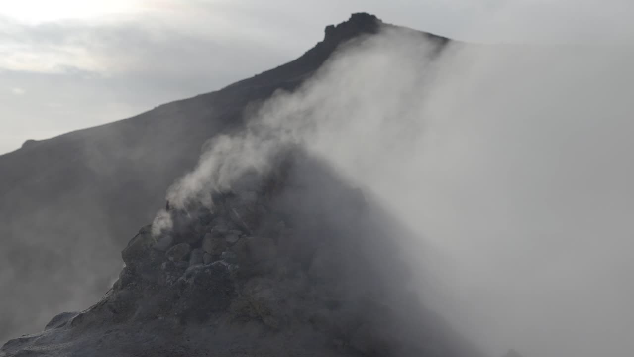 Smoky volcanic ridge in Iceland's rugged terrain