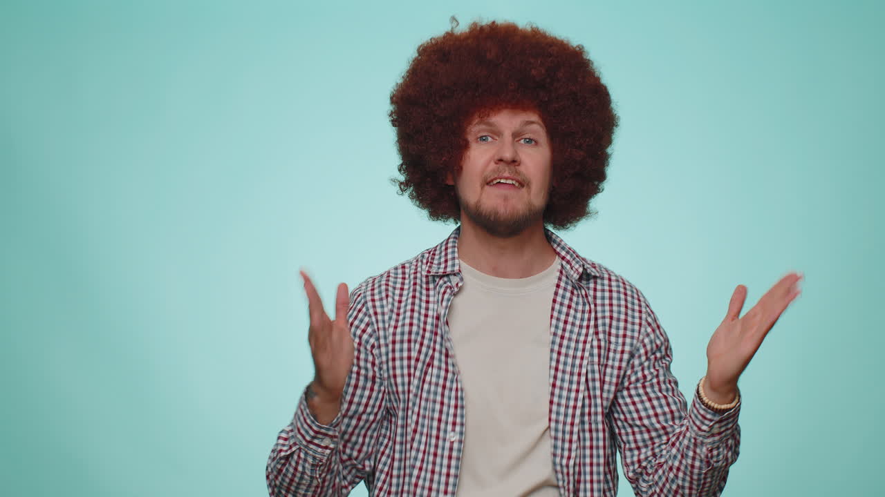 Frustrated irritated young man covering ears, avoiding advice ignoring unpleasant noise loud voices