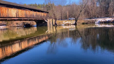 An-old,-wooden-covered-bridge-in-america-crossing-a-small-river-in-early-spring-in-new-york-state-in-the-hudson-valley