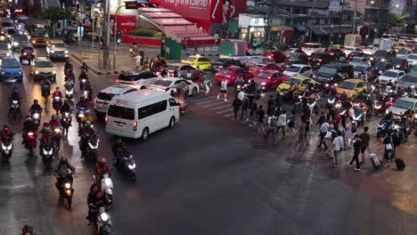 pedestrians and vehicles navigating a busy crossroad