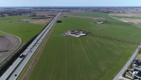 aerial-push-in-along-e6-highway,-barsebäcksverket-in-background