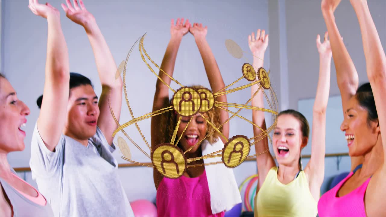 Five adults stacking hands in fitness studio sparking golden nodes pressing raising arms for cheer